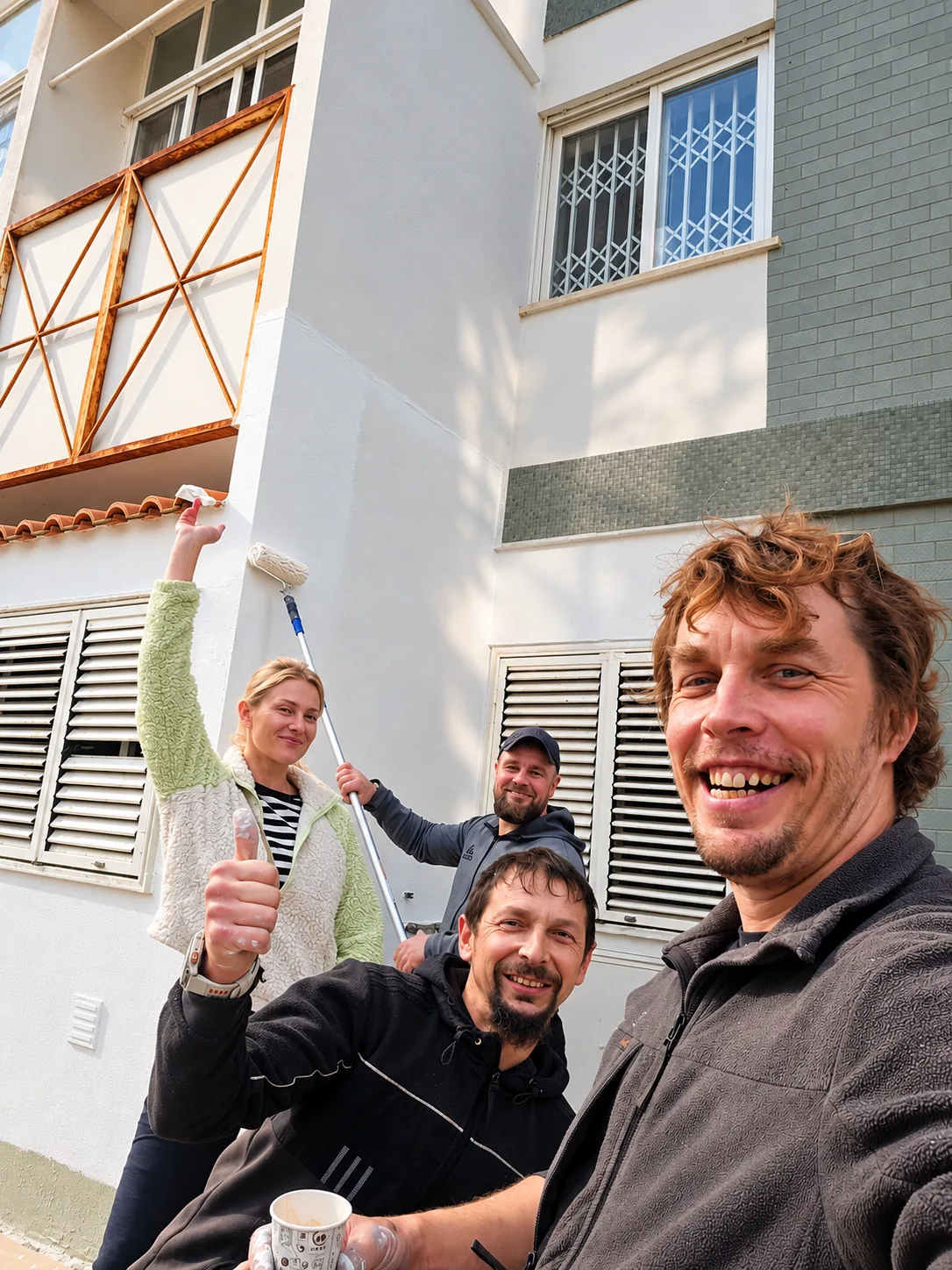 Team during exterior painting on a facade